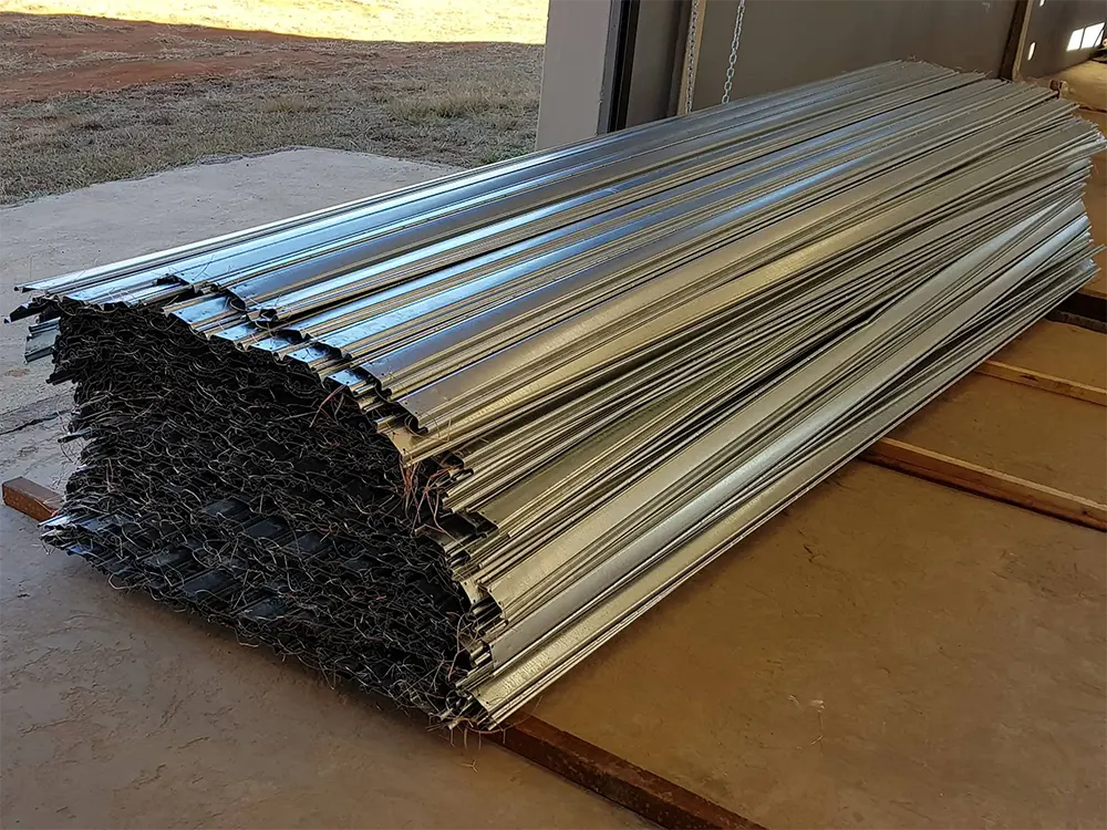 Damaged roller shutter curtain removed from its opening and laid out for repair